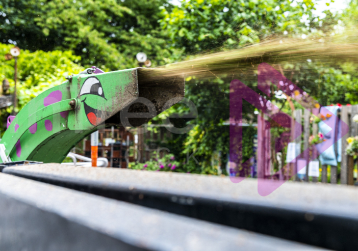 Chipper chute with a smiling face painted on it