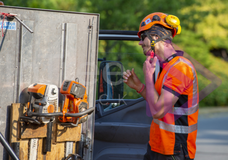 Man removing orange helmet