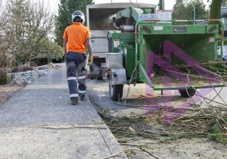 Man walking past wood chipper