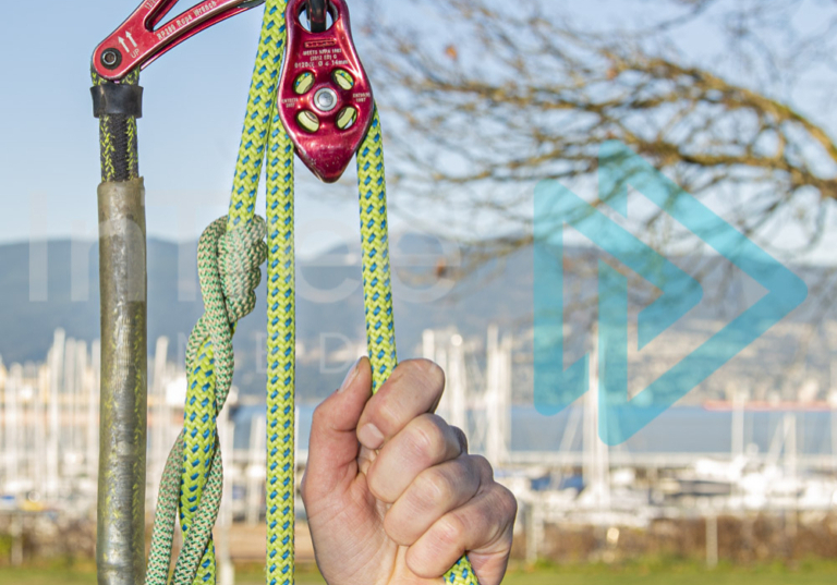 Climbing Arborist demonstrating mechanical advantage on a stationary rope system