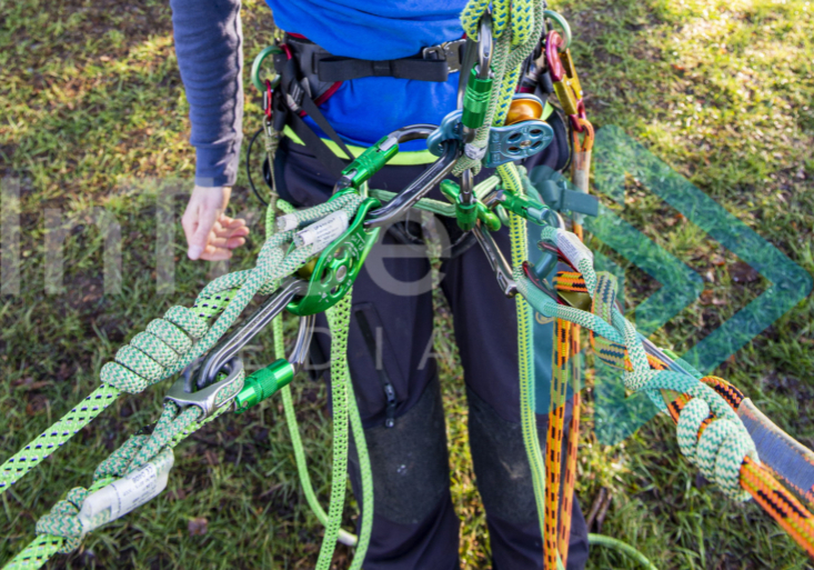 Demonstrating multiple attachment points for climbing lines and work positioning